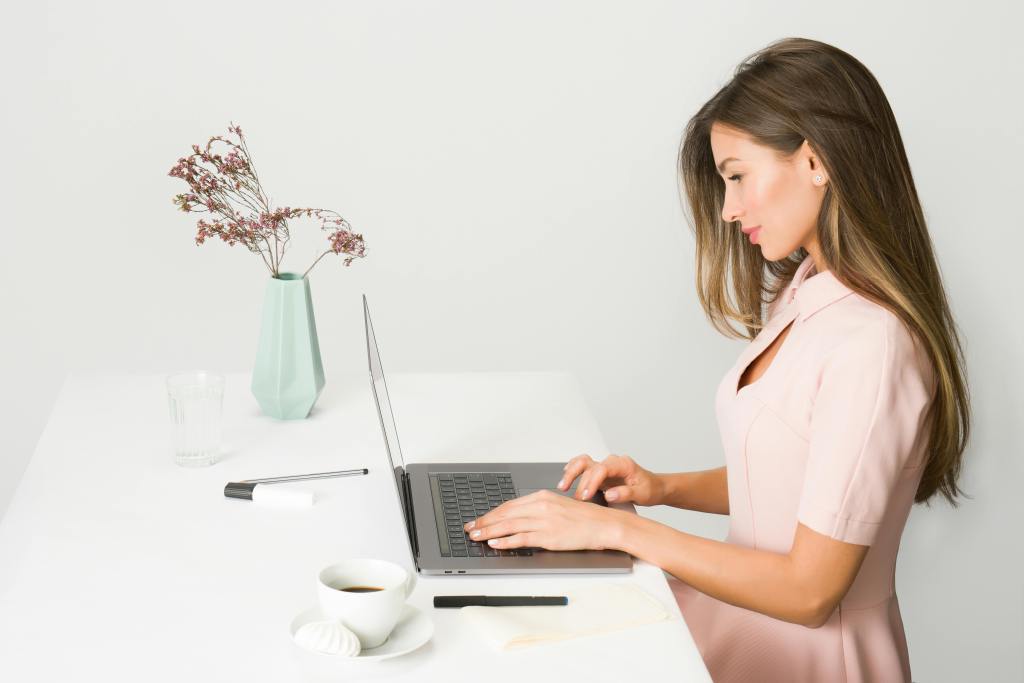 Woman sitting at a computer working.